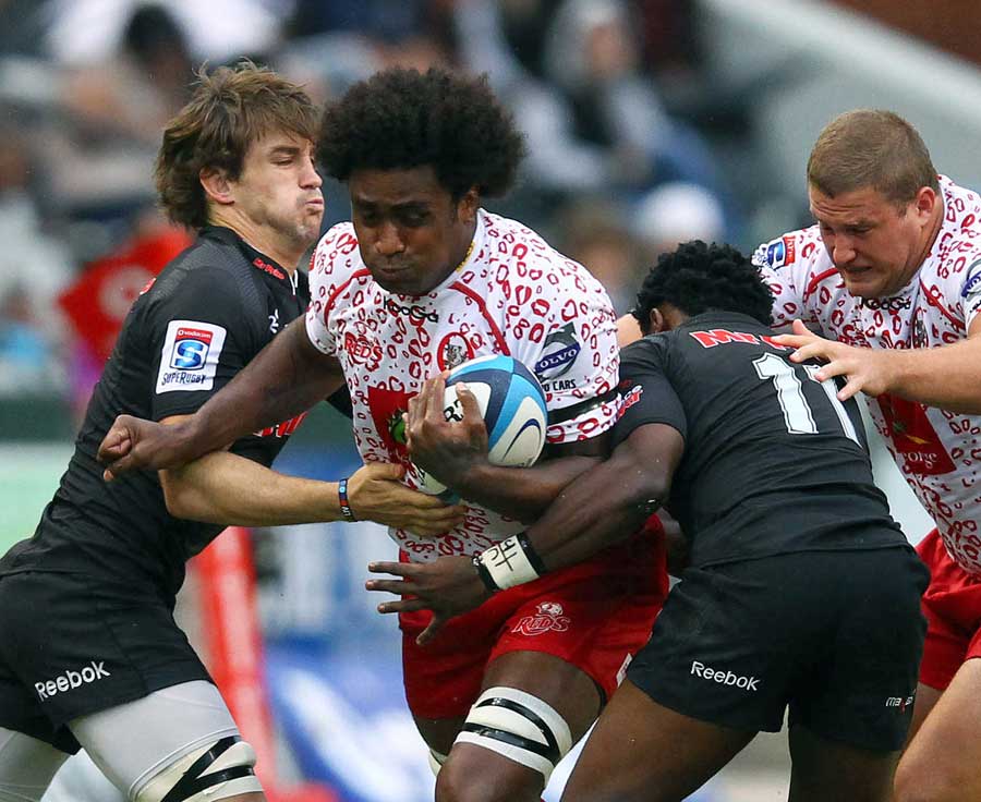 The Reds' Radike Samo tries to force his way through the Sharks defence