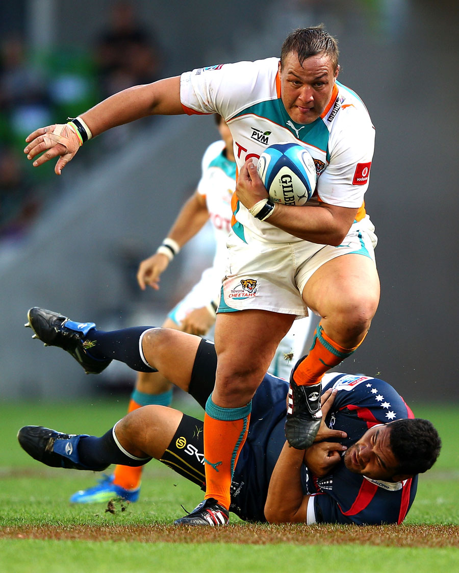 The Cheetahs' Coenraad Oosthuizen tramples over the Rebels' Rodney Blake