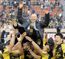 Suntory coach Eddie Jones celebrates with his players