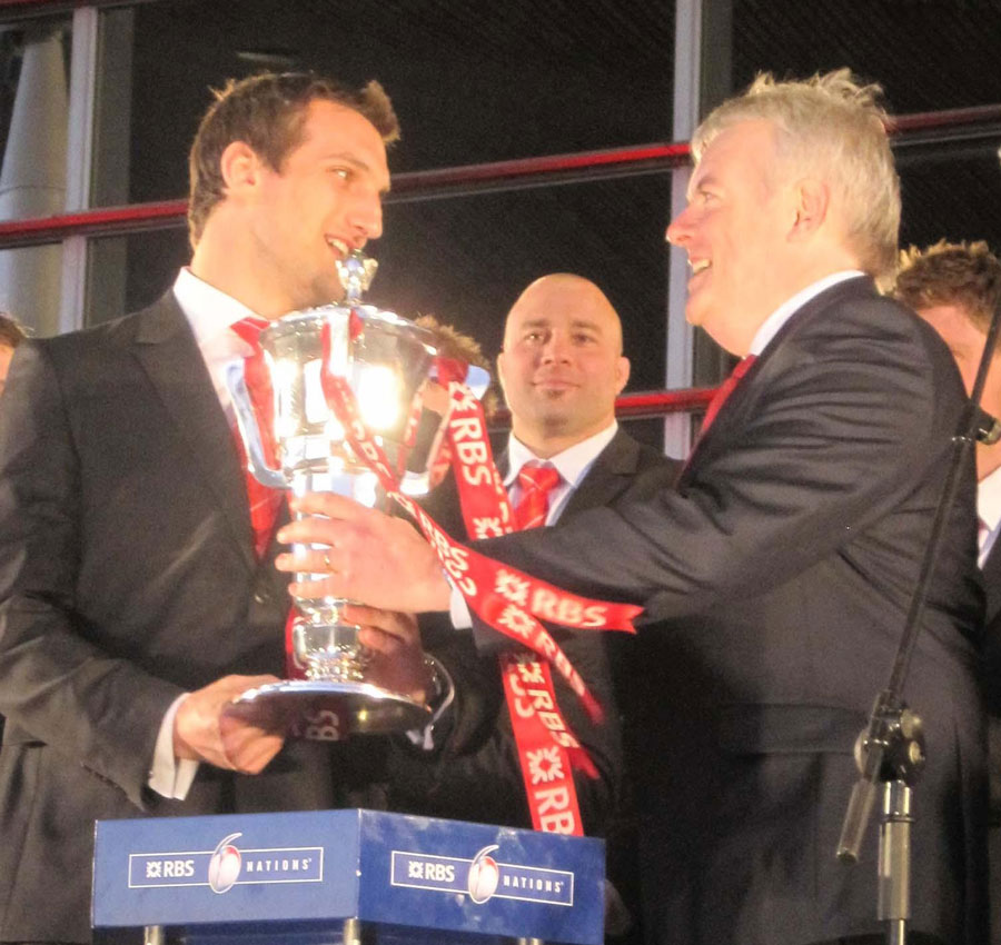 Sam Warburton takes the Six Nations trophy from Welsh First Minister Carwyn Jones