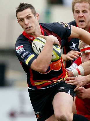The Dragons' Jason Tovey stretches the Scarlets' defence