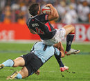 Hong Kong's Richard Smith is hit hard by the Uruguay defence
