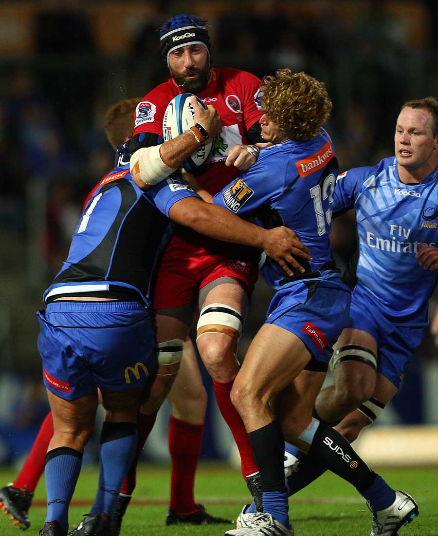 Reds lock Van Humphries is wrapped up  by the Force defence