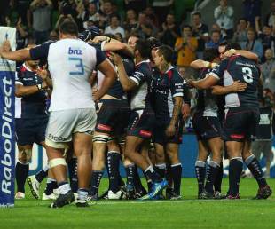 The Melbourne Rebels celebrate victory over the Blues