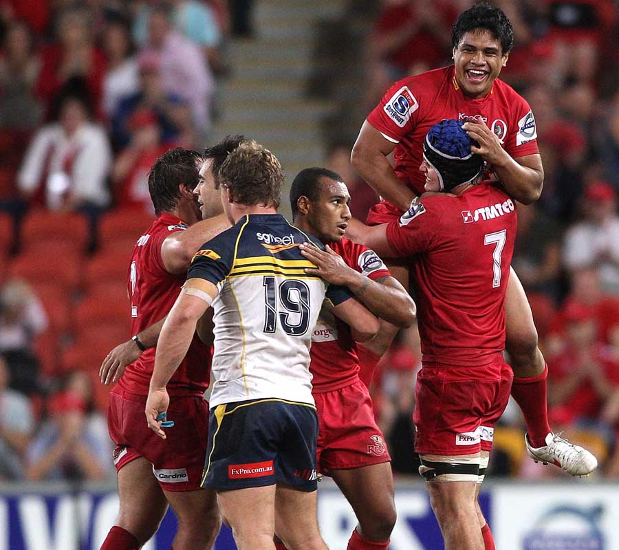 Reds centre Ben Tapuai celebrates victory with Liam Gill