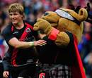Edinburgh's David Denton celebrates with the mascot