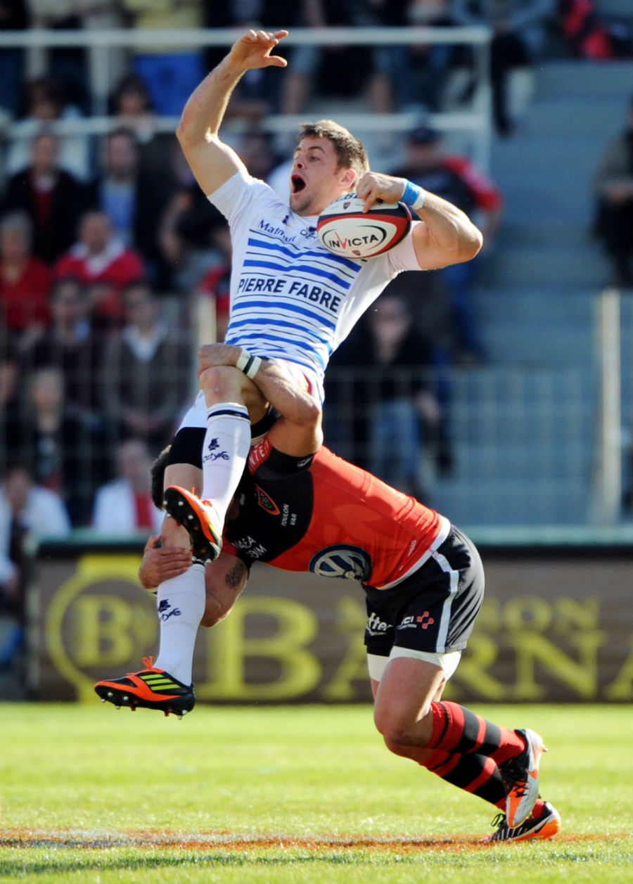 Castres' Rory Kockott is upended by the Toulon defence