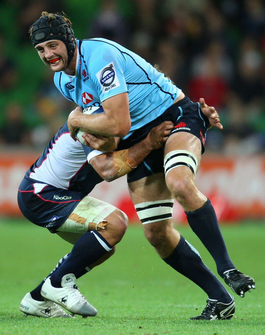 The Waratahs' Dean Mumm stretches the Rebels' defence