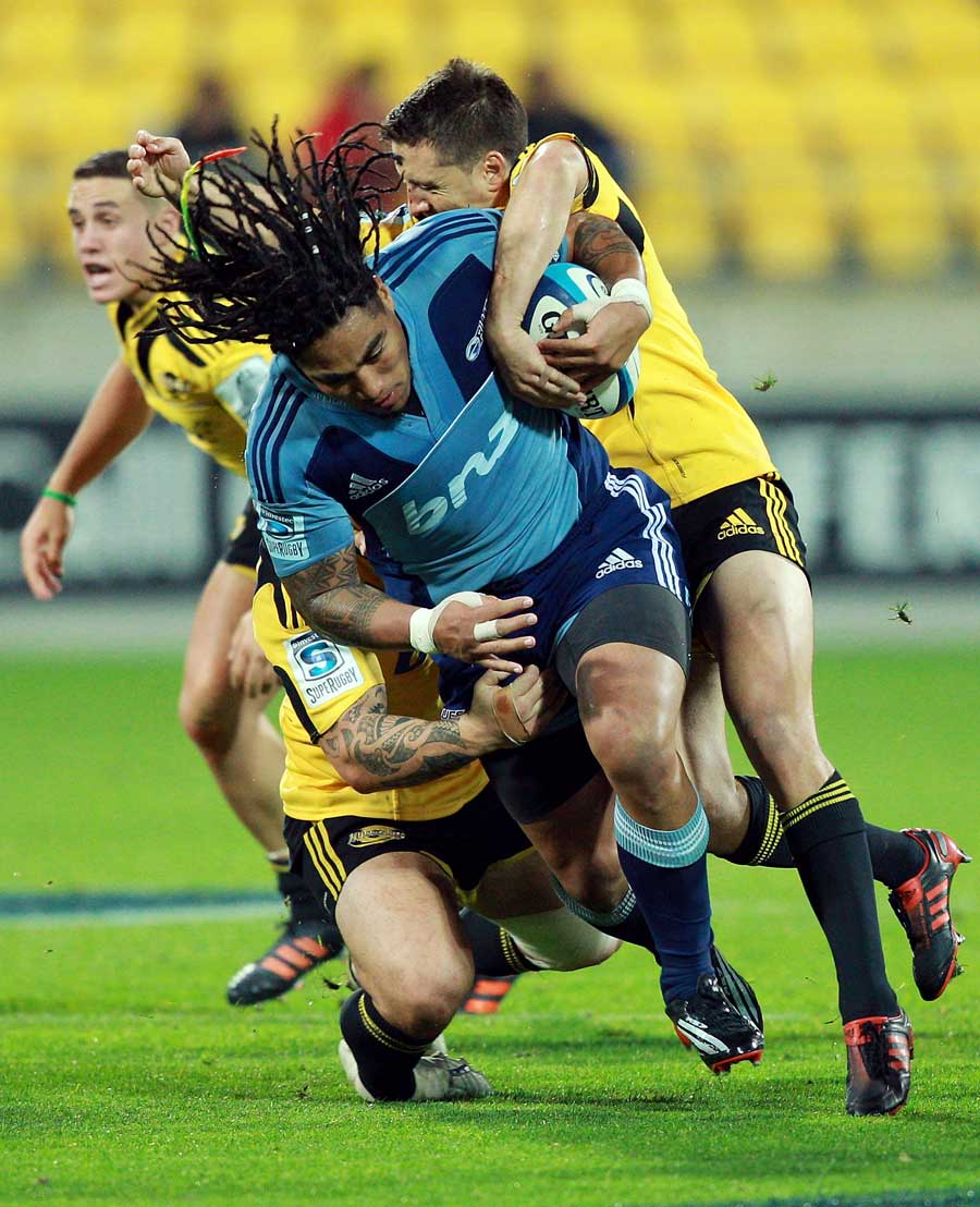 Blues centre Ma'a Nonu is wrapped up by the Hurricanes defence