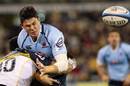 The Waratahs' Tom Carter on the end of a solid hit