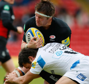 Saracens' Ernst Joubert feels the force of Phil Dollman's tackle
