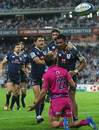 The Waratahs' Atieli Pakalani celebrates his try by throwing the ball at JJ Engelbrecht 