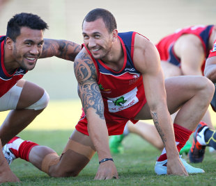 Reds' fly-half Quade Cooper warms up for training alongside wing Digby Ioane, ahead of his return to competitive rugby following his recovery from an anterior crucuate ligament injury at Ballymore Stadium, Brisbane, Australia, May 16, 2012