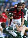 Saracens' Andy Farrell is tackled by London Irish's Mike Catt 