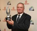 Graham Henry poses with the 2008 IRB Coach of the Year award