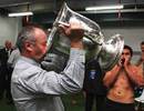 All Blacks head coach Graham Henry drinks from the Bledisloe Cup