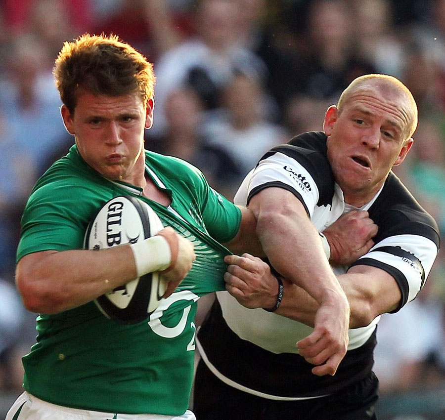Ireland's Craig Gilroy fends off the Barbarians' Mike Tindall