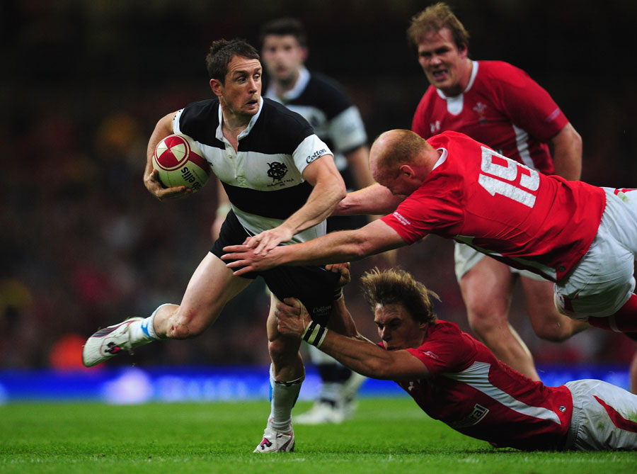 The Barbarians' Shane Williams does his best to evade two Welsh tacklers