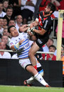 Castres' Chris Masoe and Toulouse's Clement Poitrenaud compete for the ball