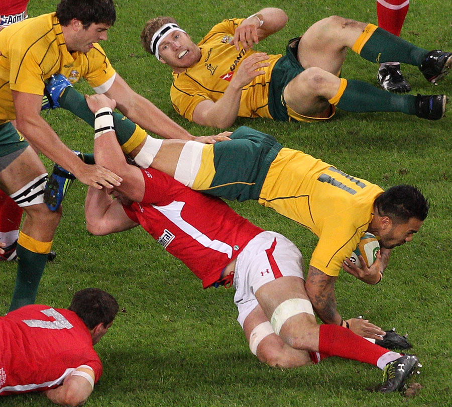 Australia's Digby Ioane is felled by the Wales defence