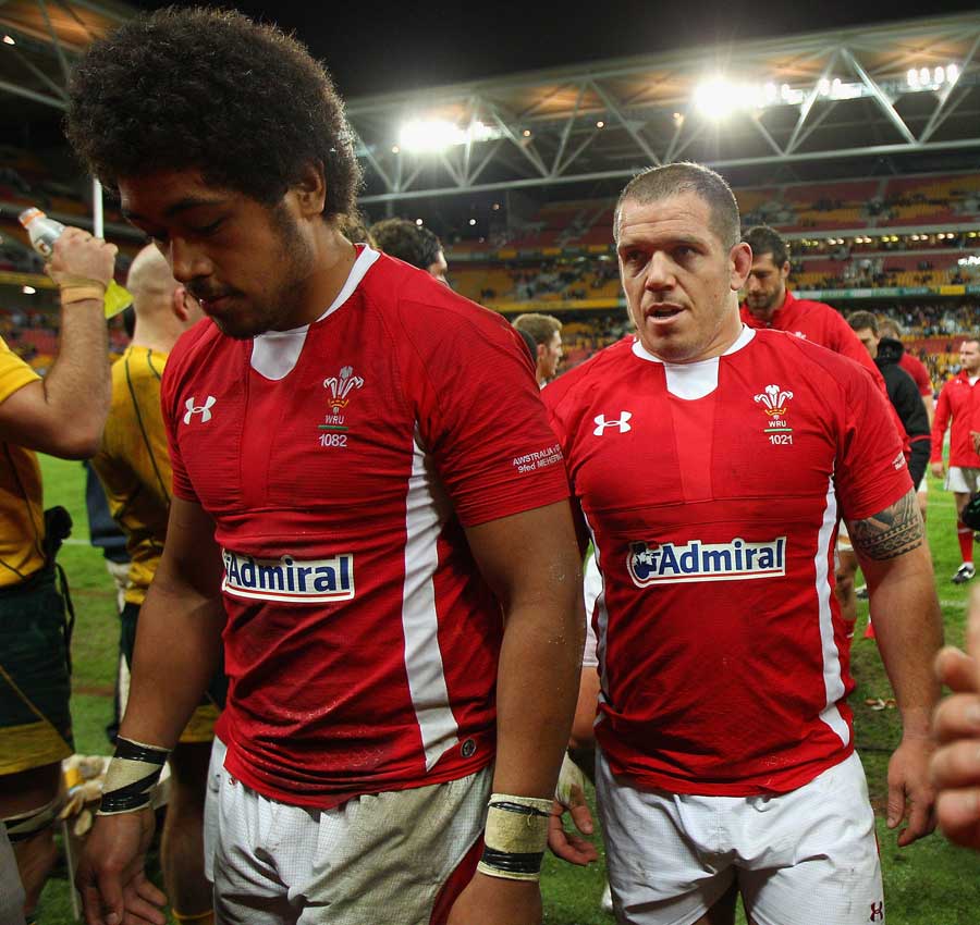 Wales forwards Toby Faletau and Paul James trudge from the field
