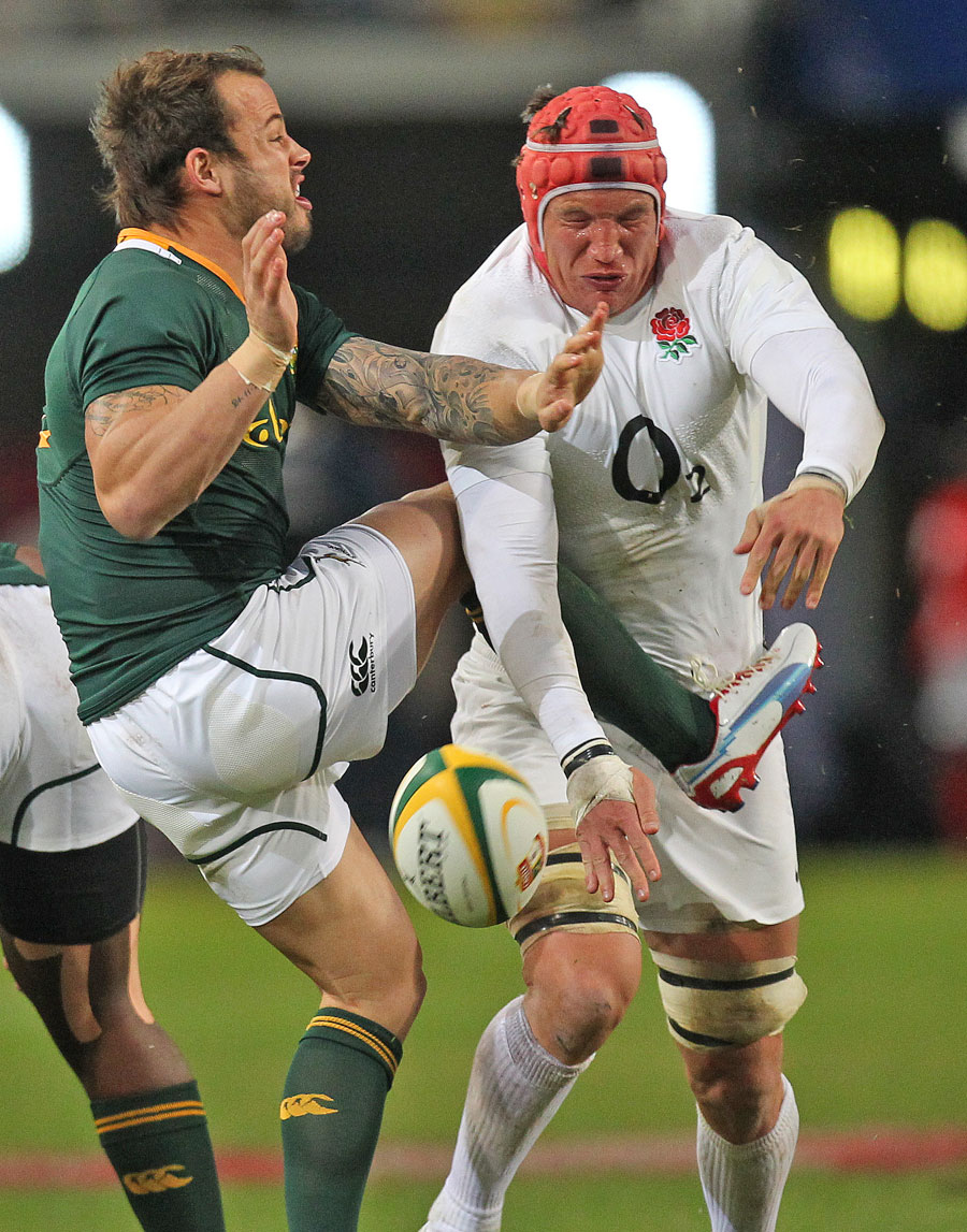 England's Tom Johnson blocks a clearance by South Africa's Francois Hougaard