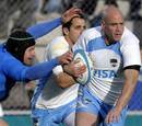 Argentina's Felipe Contepomi evades Italy fly-half Kris Burton
