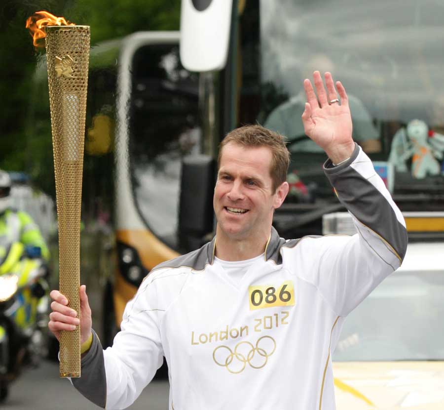 Former Scotland international Chris Paterson carries the Olympic Flame