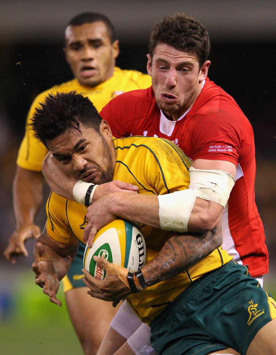 Australia's Digby Ioane is wrapped up by Alex Cuthbert
