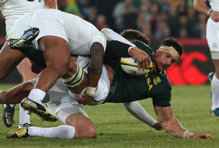 South Africa's Pierre Spies is halted by the England defence