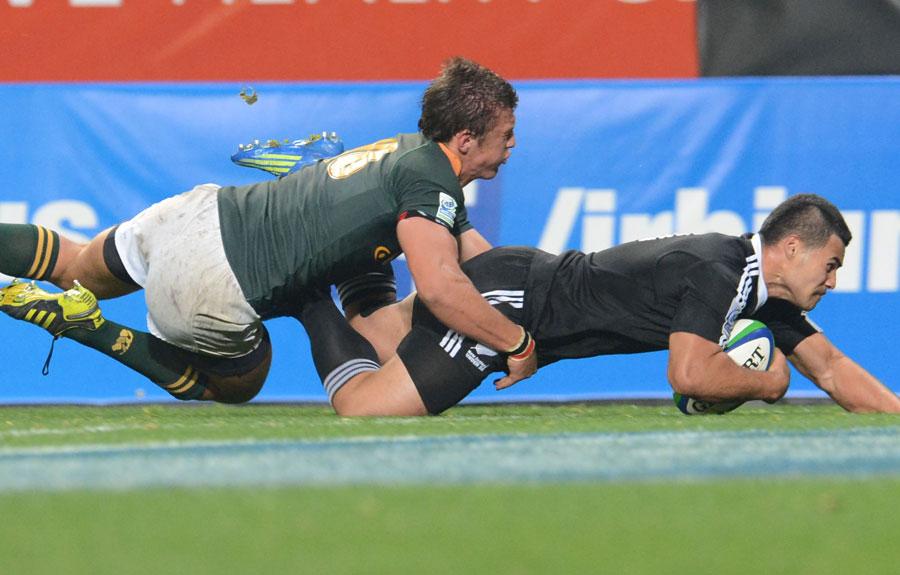 New Zealand's Milford Keresoma slides in to score