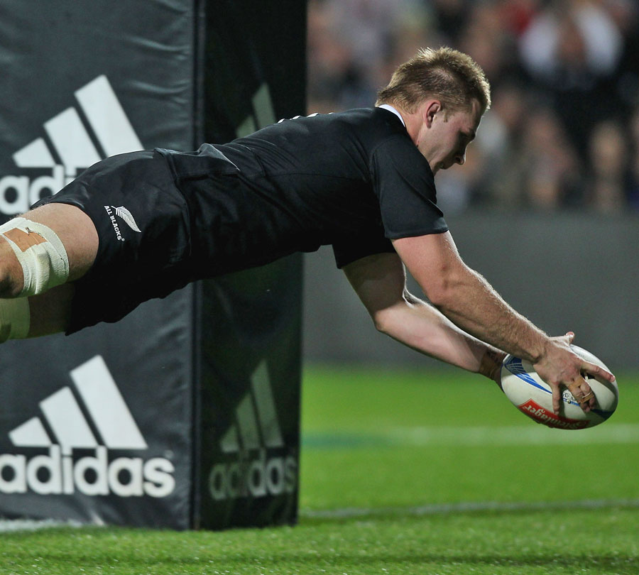 New Zealand's Sam Cane dives over to score