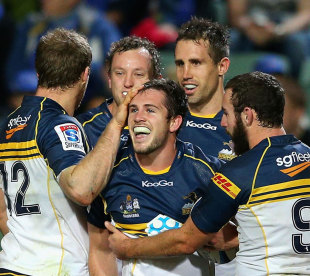 The Brumbies celebrate Zack Holmes' try against the Force