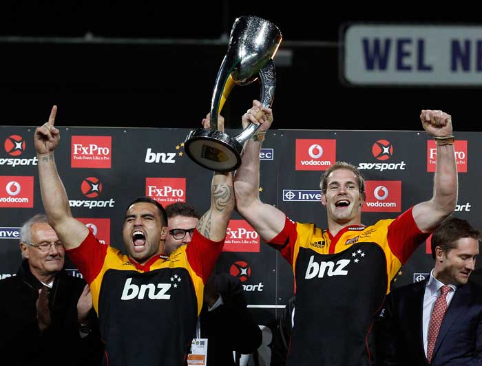 Chiefs skipper Craig Clarke and team-mate Liam Messam lift the Super Rugby trophy