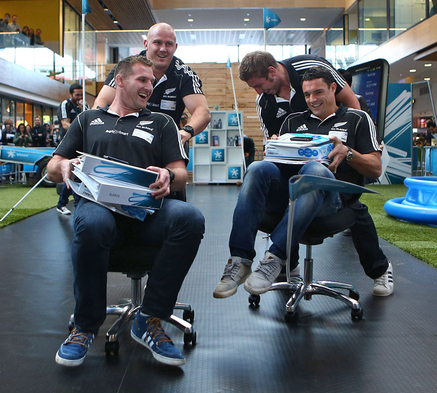 The All Blacks take part in an office chair race