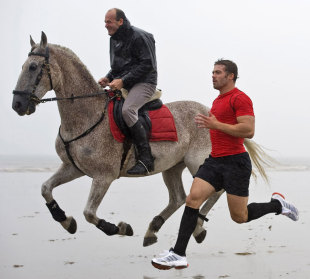 Wales' Leigh Halfpenny races a horse as part of a TV campaign, Rest Bay, Porthcawl, Wales, August 27, 2012