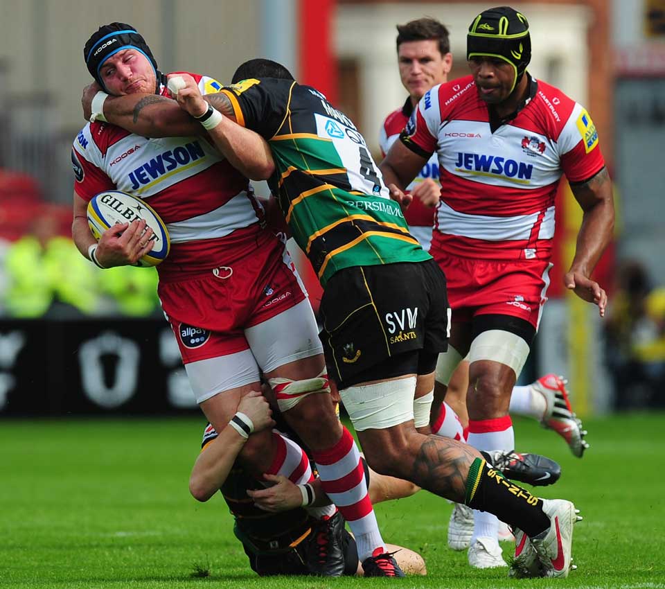 Gloucester No.8 Ben Morgan is wrapped up by the Northampton defence