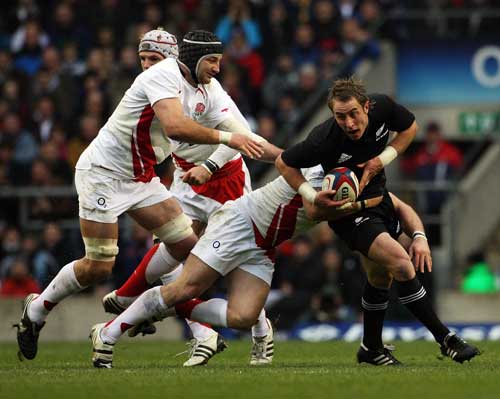New Zealand's Jimmy Cowan is tackled by England's Steve Borthwick