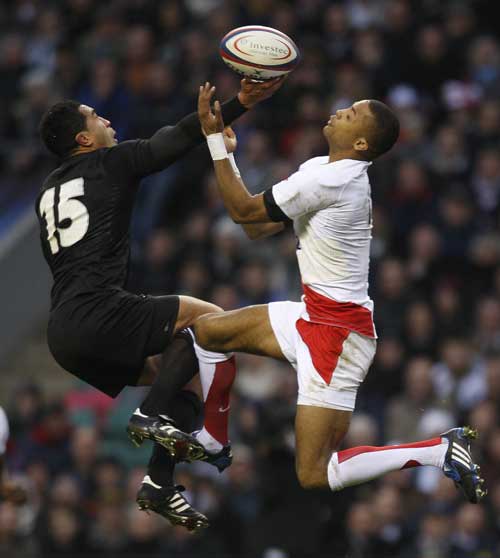 New Zealand's full back Mils Muliaina jumps for the ball against England's full back Delon Armitage