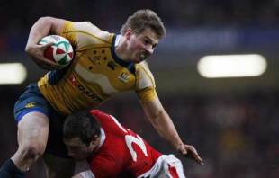 Australia's Drew Mitchell is tackled on the line by Wales' Andrew Bishop 