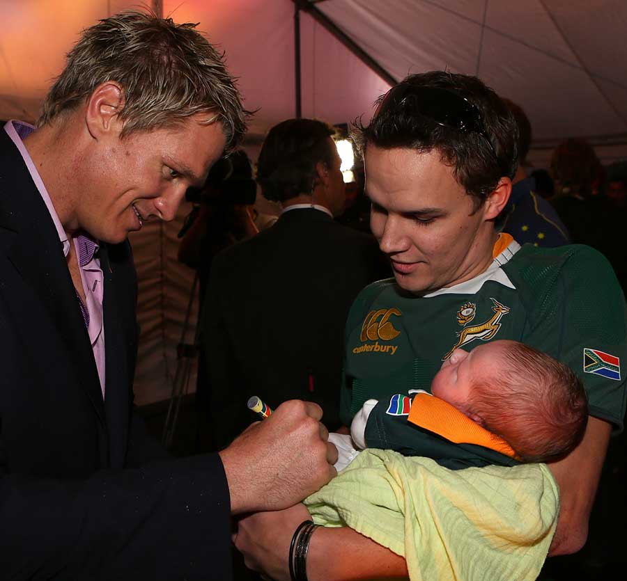 South Africa's Jean de Villiers signs a young supporter