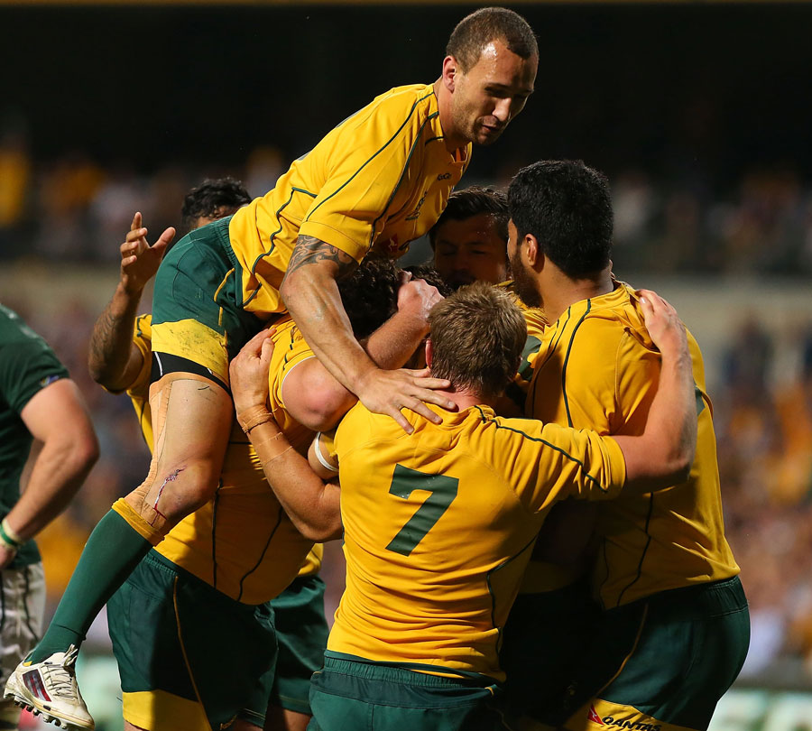 Australia's Scott Higginbotham is engulfed after scoring