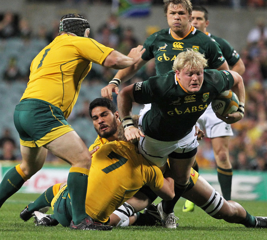 South Africa's Adrian Strauss is felled by the Australia defence