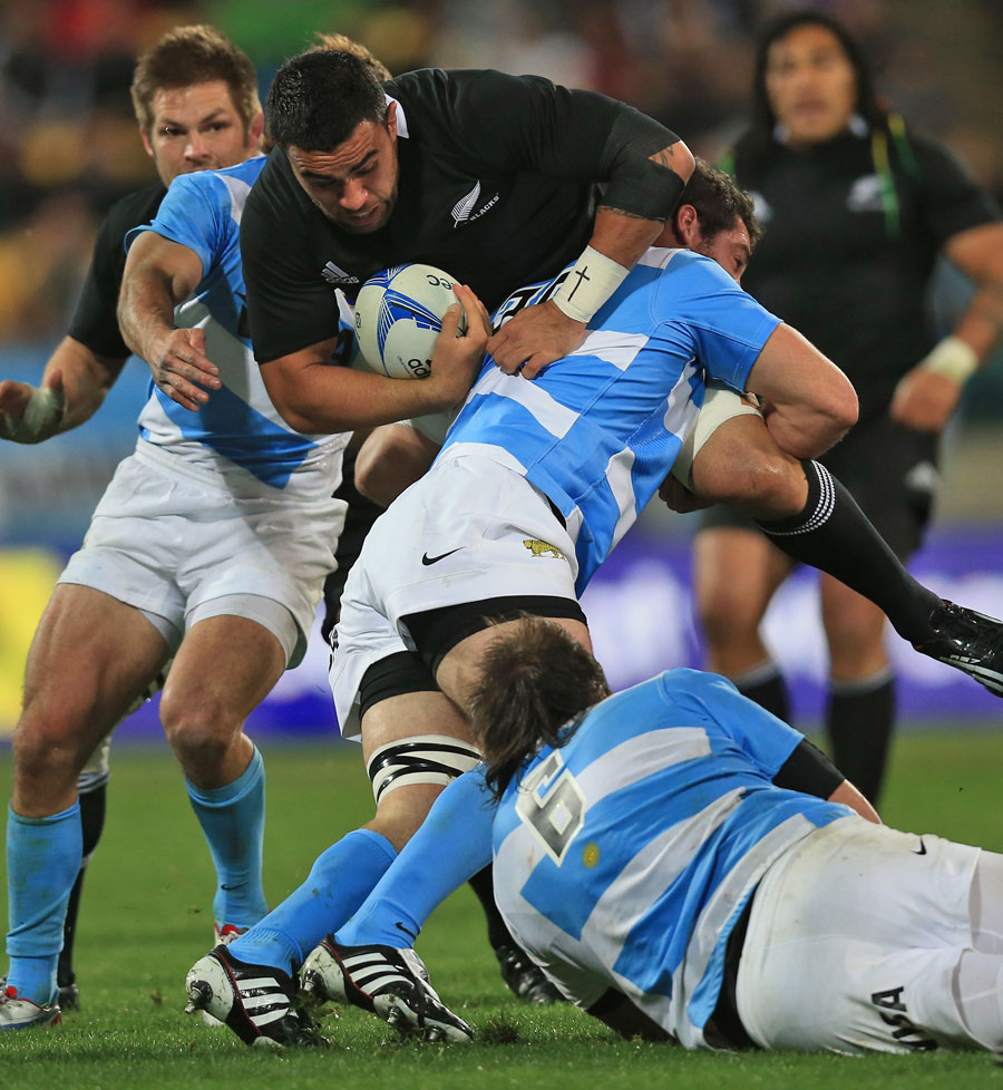 New Zealand's Liam Messam is wrapped up by Argentina