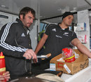 New Zealand's Andrew Hore and Israel Dagg serve food to fans