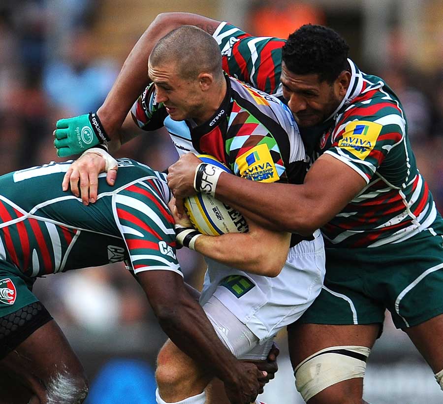 Harlequins' Mike Brown is wrapped up by the Tigers defence