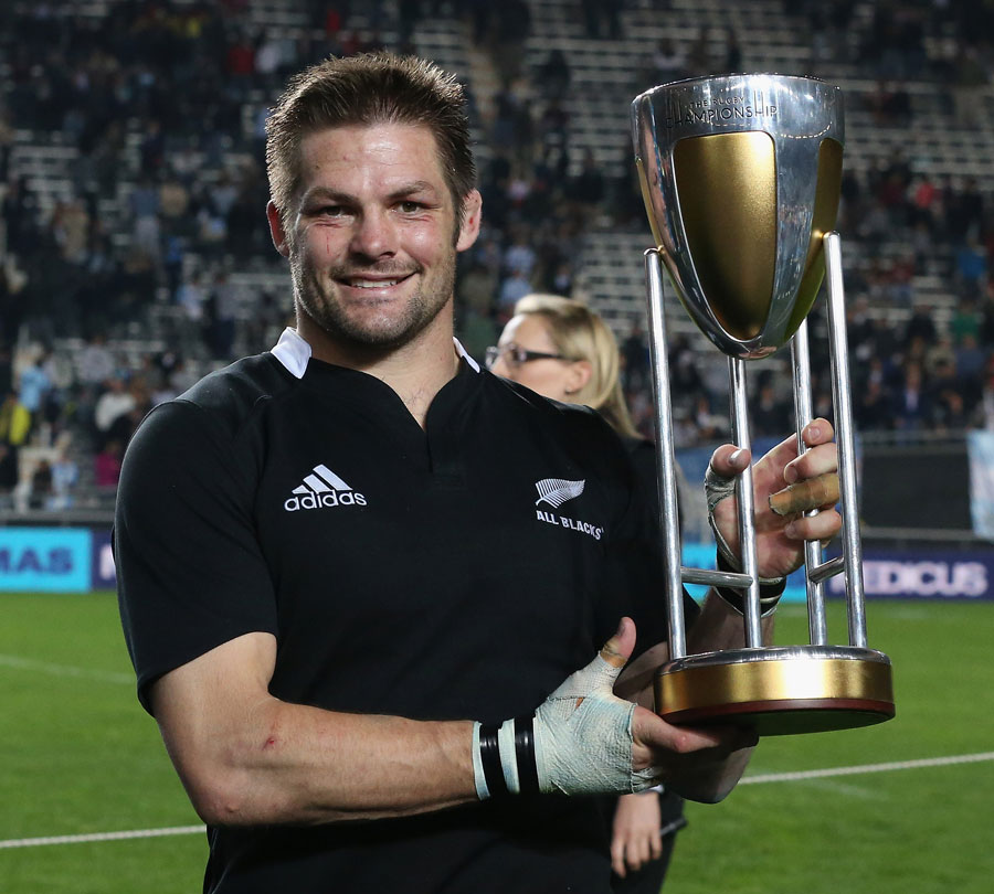 New Zealand's Richie McCaw poses with the Rugby Championship silverware