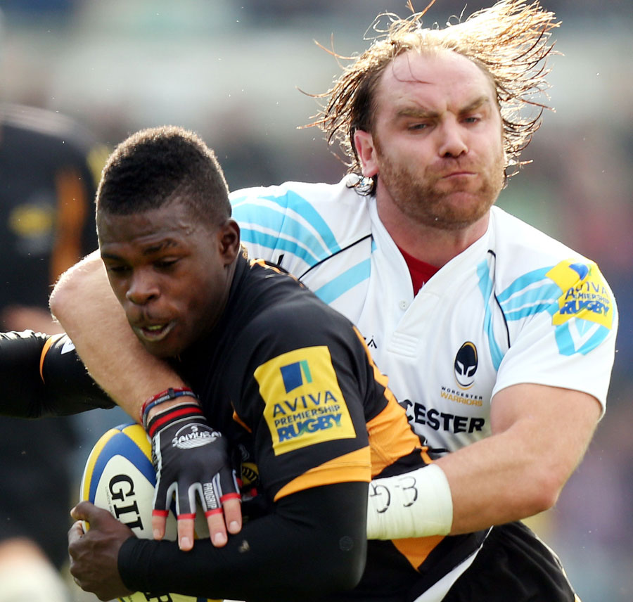 London Wasps' Chrisian Wade is tackled by Worcester's Andy Goode