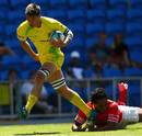 Australia's Sean McMahon skips clear of a Tongan tackler