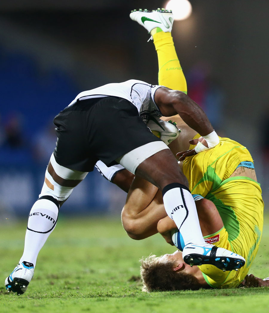 Australia's Jesse Parahi is up-ended in a tackle